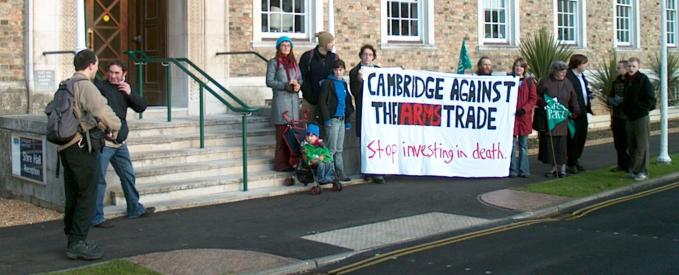 13 Dec 2005: 12 people at entrance to Shire Hall, Cambridge, with a banner that reads 'CAMBRIDGE AGAINST THE ARMS TRADE Stop investing in death'