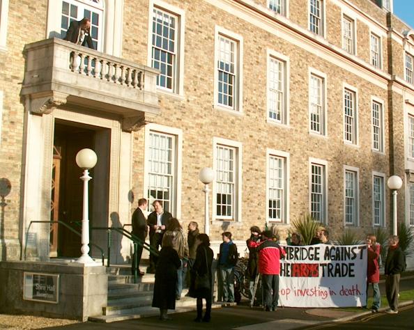 Outside Shire Hall, BBC cameraman, around 12 people, banner 'CAMBRIDGE AGAINST THE ARMS TRADE Stop investing in death', Cambridge 13 Dec 2005
